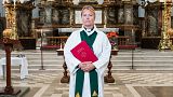 Priest Sandra Signarsdotter poses for a picture ahead of the Sunday service at Gustaf Vasa Church in Odenplan, Stockholm on August 23, 2020