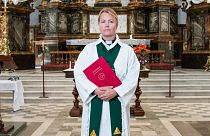 Priest Sandra Signarsdotter poses for a picture ahead of the Sunday service at Gustaf Vasa Church in Odenplan, Stockholm on August 23, 2020