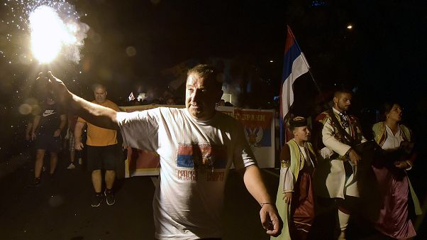 An opposition supporter lights torch during church-led protest in Podgorica, Montenegro, Thursday, Aug. 27, 2020. An opposition supporter lights torch during church-led protest in Podgorica, Montenegro, Thursday, Aug. 27, 2020.