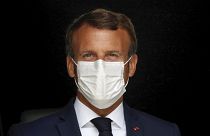 French President Emmanuel Macron, wearing a protective face mask, as he visits a site of pharmaceutical group Seqens, in Villeneuve-la-Garenne, near Paris, August 28, 2020.