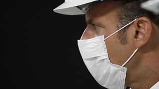 Emmanuel Macron wearing a protective mask in Villeneuve-la-Garenne, near Paris, Friday Aug. 28, 2020