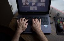 A man takes part in a video conference as he works from home, on May 14, 2020 in Vertou, outside Nantes