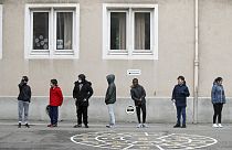In this Thursday, May 14, 2020 file photo, schoolchildren wait in line to go back in their classroom at the Sainte Aurelie primary school of Strasbourg.