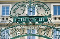 The gate is pictured outside a town hall in France.