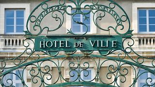 The gate is pictured outside a town hall in France.