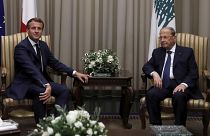 Lebanese President Michel Aoun, right, welcomes French President Emmanuel Macron at Beirut International airport, Monday, Aug. 31, 2020.