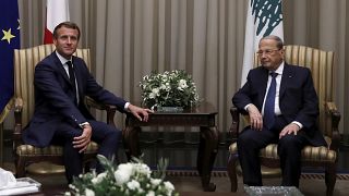 Lebanese President Michel Aoun, right, welcomes French President Emmanuel Macron at Beirut International airport, Monday, Aug. 31, 2020.