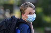 A child in Gelsenkirchen, Germany, returns to school wearing a mask. Wednesday, Aug. 12, 2020.