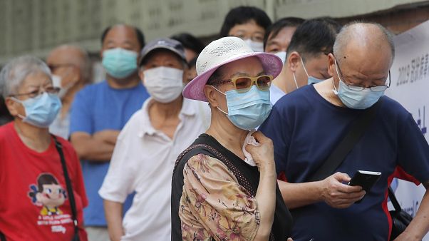 People wearing face masks queue for the coronavirus test outside a testing center in Hong Kong, Tuesday, Sept. 1, 2020. People wearing face masks queue for the coronavirus test outside a testing center in Hong Kong, Tuesday, Sept. 1, 2020.