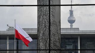 FILE - The Polish flag flies outside the German Chancellery in Berlin, 2018.