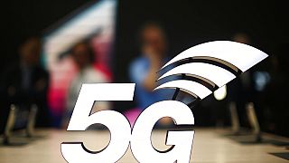 This Feb. 25, 2019 file photo shows a banner of the 5G network is displayed during the Mobile World Congress wireless show, in Barcelona, Spain