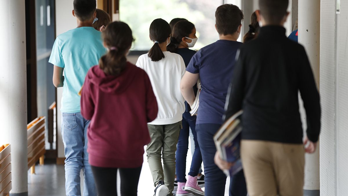 Schoolchildren walk back to their classroom after a break in Bischheim, outside Strasbourg, eastern France, Sept.1, 2020. 