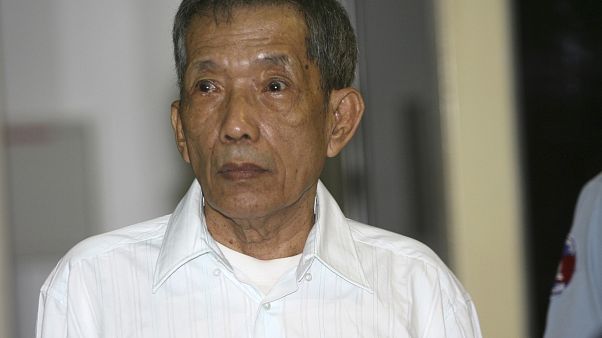 FILE - In this March 30, 2020, file photo, the former Khmer Rouge prison chief looks on during the first day of a U.N.-backed tribunal in Phnom Penh, Cambodia. FILE - In this March 30, 2020, file photo, the former Khmer Rouge prison chief looks on during the first day of a U.N.-backed tribunal in Phnom Penh, Cambodia.