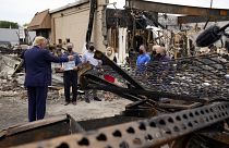 President Donald Trump talks to business owners Tuesday, Sept. 1, 2020, as he tours an area damaged during demonstrations after a police officer shot Jacob Blake in Kenosha.