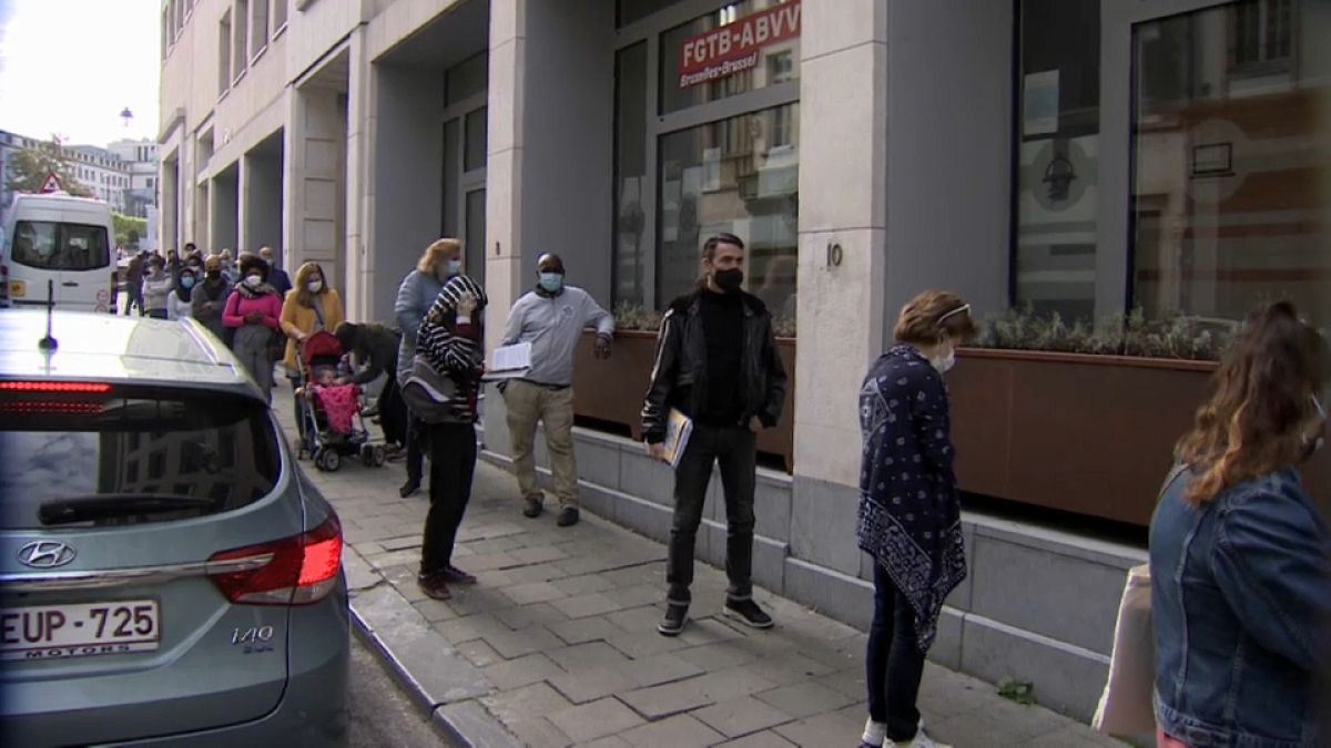 Belgium furloughed workers queue up at job centre, Brussels 2020.