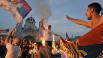 Opposition supporters celebrate the election results outside the Serbian Orthodox Church of Christ's Resurrection in Podgorica, Montenegro.