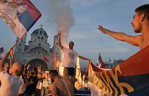 Opposition supporters celebrate the election results outside the Serbian Orthodox Church of Christ's Resurrection in Podgorica, Montenegro.