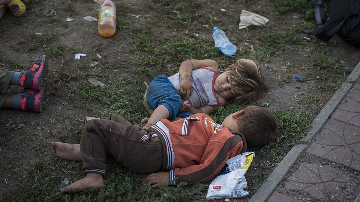 Syrian children sleep in a park in Belgrade, Serbia