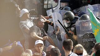 Police scuffle with protesters during rally in front of the new National Assembly building, demanding government resignation in Sofia on Wednesday, Sept. 2, 2020.
