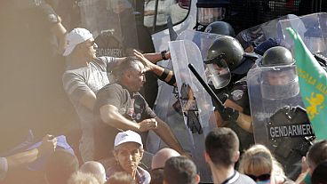 Police scuffle with protesters during rally in front of the new National Assembly building, demanding government resignation in Sofia on Wednesday, Sept. 2, 2020. 