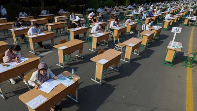 Uzbek students take open-air entrance exams in Tashkent.