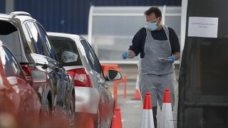 Staff work at a the COVID-19 testing facility at Ikea near the Wembley stadium in London, Wednesday, April 29, 2020. 