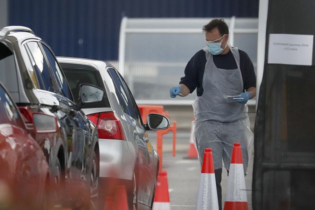 Staff work at a the COVID-19 testing facility at Ikea near the Wembley stadium in London, Wednesday, April 29, 2020. 