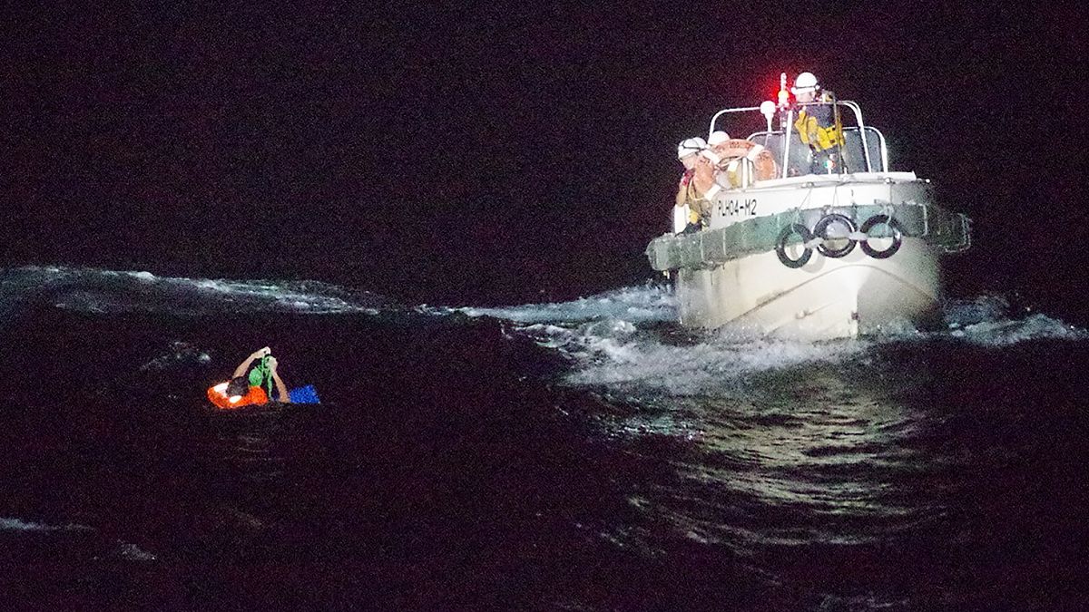 In this photo released by the 10th Regional Japan Coast Guard Headquarters, a Filipino crewmember of a Panamanian cargo ship is rescued by Japanese Coast Guard members.
