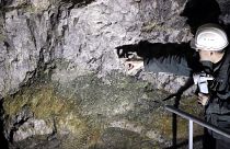 One of the four founders of Geomet company, points at ore containing lithium inside a former mine located at the border with Germany near Cinovec, Czech Republic.