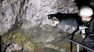 One of the four founders of Geomet company, points at ore containing lithium inside a former mine located at the border with Germany near Cinovec, Czech Republic.