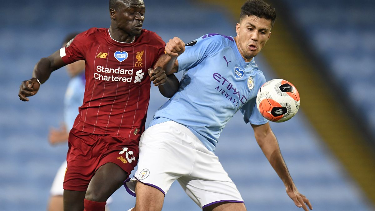 Liverpool's Sadio Mane and Manchester City's Rodri in action during a Premier League match in July.