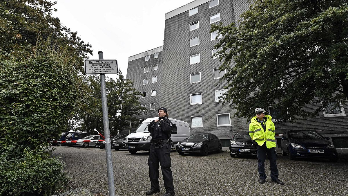 Police secure the entrance of a house where five dead children were found in Solingen, Germany