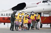 Residents arrive at a heliport in Kagoshima, southern Japan Friday, Sept. 4, 2020, to take refuge ahead of a powerful typhoon.