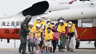 Residents arrive at a heliport in Kagoshima, southern Japan Friday, Sept. 4, 2020, to take refuge ahead of a powerful typhoon.