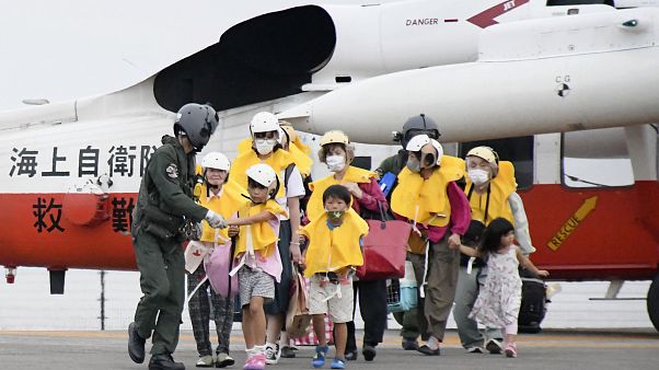 Residents arrive at a heliport in Kagoshima, southern Japan Friday, Sept. 4, 2020, to take refuge ahead of a powerful typhoon. Residents arrive at a heliport in Kagoshima, southern Japan Friday, Sept. 4, 2020, to take refuge ahead of a powerful typhoon.