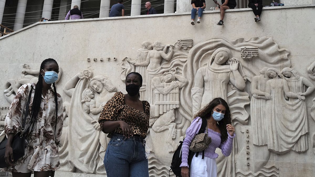 Women walk at The Palais de Tokyo Museum wearing a protective face mask as a precaution against the coronavirus in Paris, Saturday, Sept. 5, 2020.