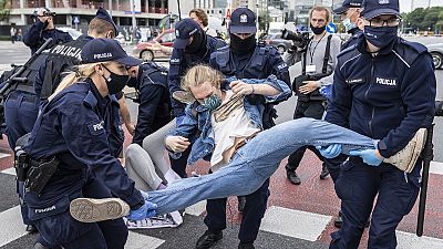 Aktivisten von Extinction Rebellion werden in Warschau von Polizisten weggetragen