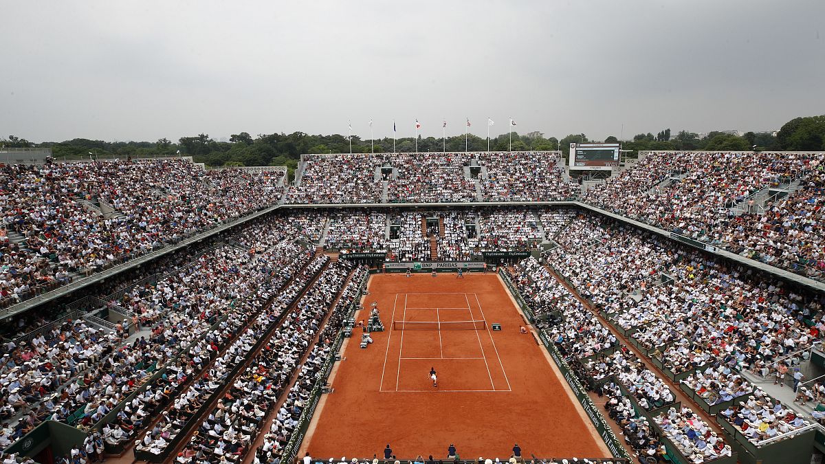 In this June 10, 2018 file photo, the crowd watch Austria's Dominic Thiem serving to Spain's Rafael Nadal during the men's final match of the French Open.