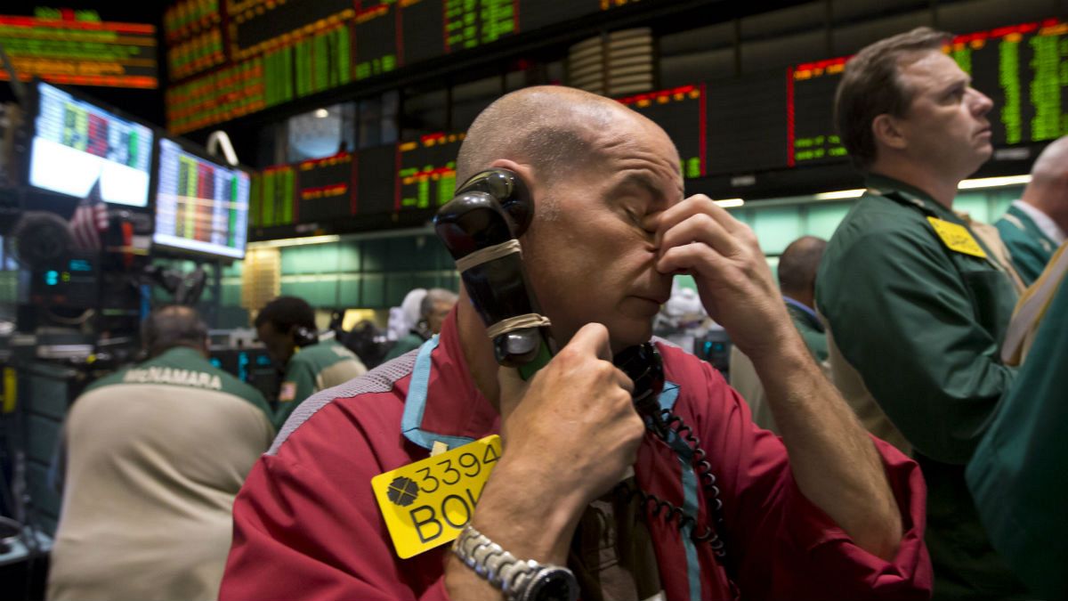 Traders work in the oil options pit at the New York Mercantile Exchange