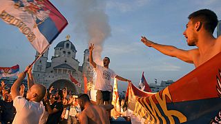 Opposition supporters celebrate after the parliamentary elections in front of the Serbian Orthodox Church of Christ's Resurrection in Podgorica, Montenegro, Monday, Aug. 31