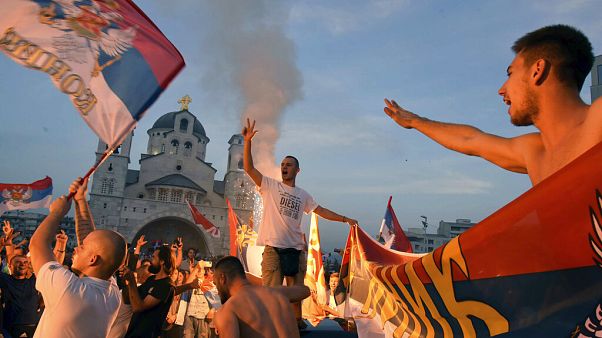 Opposition supporters celebrate after the parliamentary elections in front of the Serbian Orthodox Church of Christ's Resurrection in Podgorica, Montenegro, Monday, Aug. 31 Opposition supporters celebrate after the parliamentary elections in front of the Serbian Orthodox Church of Christ's Resurrection in Podgorica, Montenegro, Monday, Aug. 31