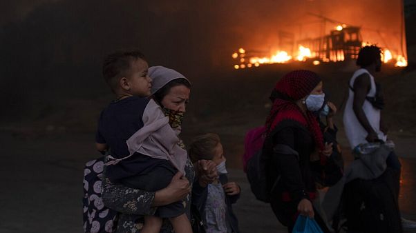Migrants flee from the Moria refugee camp during a second fire, on the northeastern Aegean island of Lesbos, Greece, on Wednesday, Sept. 9, 2020. F Migrants flee from the Moria refugee camp during a second fire, on the northeastern Aegean island of Lesbos, Greece, on Wednesday, Sept. 9, 2020. F
