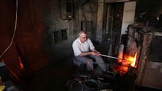 الحرفي في صنااعة الزجاج محمد حلاق يعمل في ورشته في دمشق. 2020/06/23