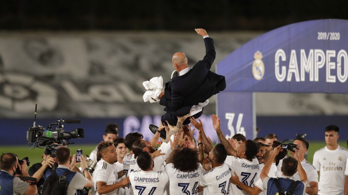 Real Madrid's players throw on the air their head coach Zinedine Zidane, as they celebrate after winning the Spanish La Liga 2019-2020 