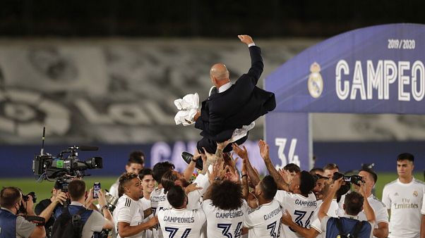 Real Madrid's players throw on the air their head coach Zinedine Zidane, as they celebrate after winning the Spanish La Liga 2019-2020 Real Madrid's players throw on the air their head coach Zinedine Zidane, as they celebrate after winning the Spanish La Liga 2019-2020