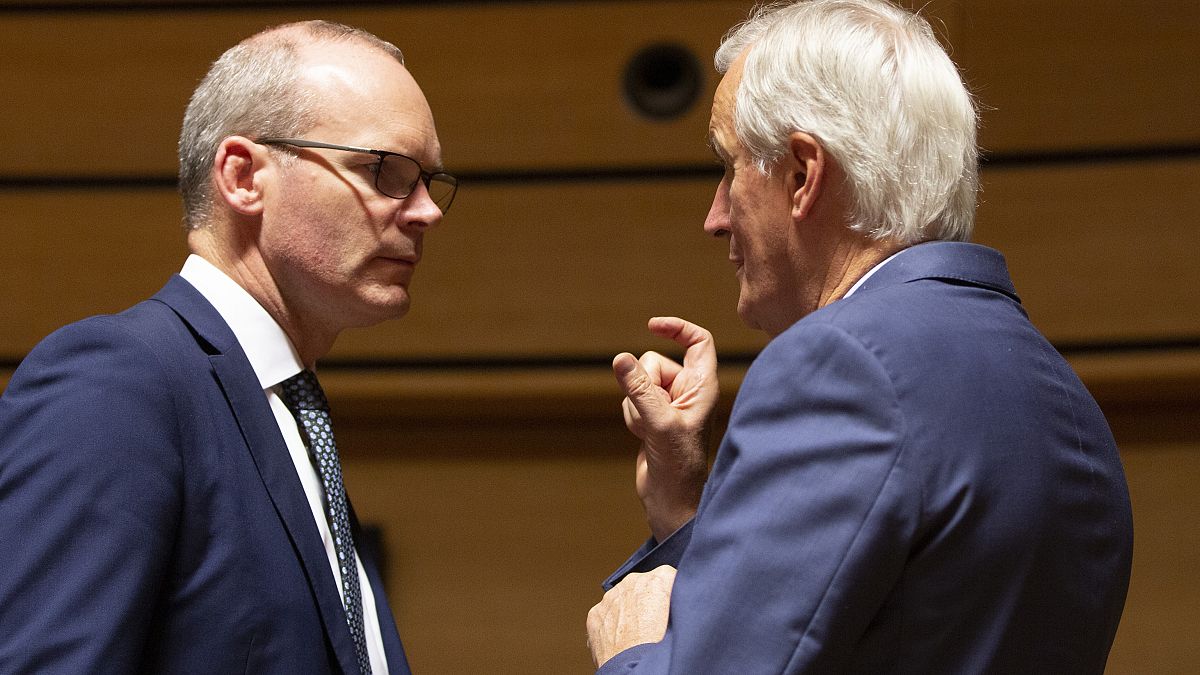 European Union chief Brexit negotiator Michel Barnier, right, speaks with Irish Foreign Minister Simon Coveney, left, during meeting of EU General Affairs ministers, Oct 2019