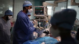 Medical workers tend to a patient affected with COVID-19 in a Marseille hospital, southern France, Thursday, Sept.10, 2020.