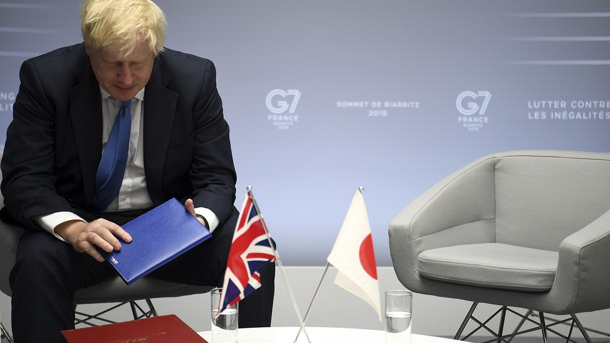 FILE: Boris Johnson sits after bilateral talks with Japanese Prime Minister Shinzo Abe during the G7 summit in Biarritz, southwestern France, Aug. 26, 2019 