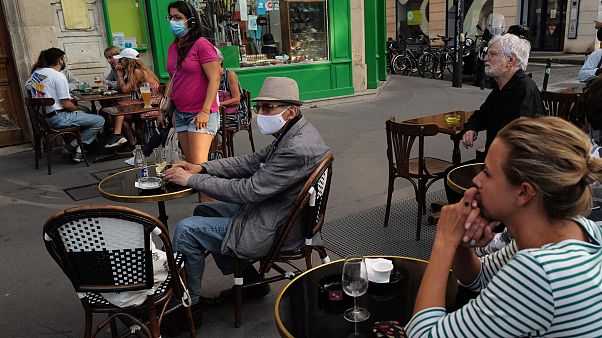 People, wearing a protective face mask as a precaution against the coronavirus, sit on the terrace of a cafe, in Paris. September 10, 2020 