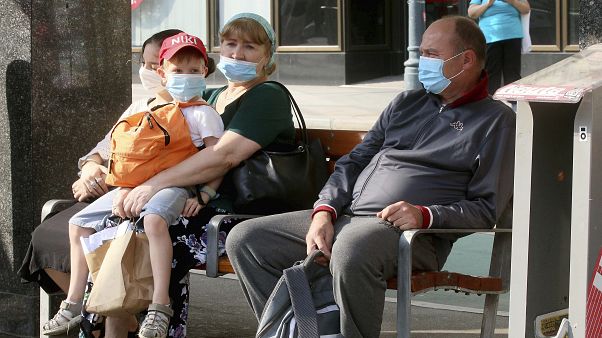 People wear face mask as they sit on a public seat near to the Vienna Opera station, in Vienna, Aug. 13, 2020. People wear face mask as they sit on a public seat near to the Vienna Opera station, in Vienna, Aug. 13, 2020.